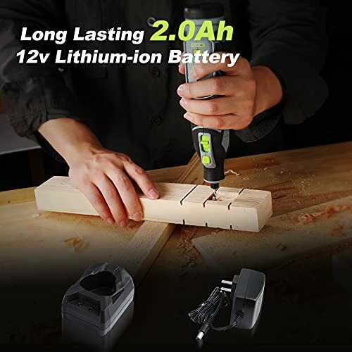 Person using a cordless drill on a wooden plank with a charger and battery shown.