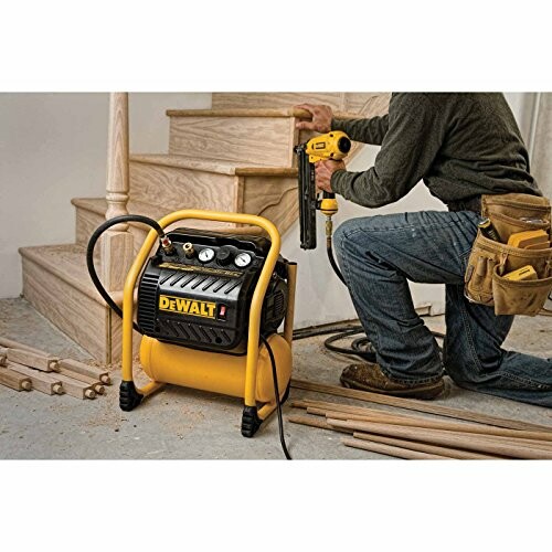 Person using a DEWALT air compressor for woodworking on stairs
